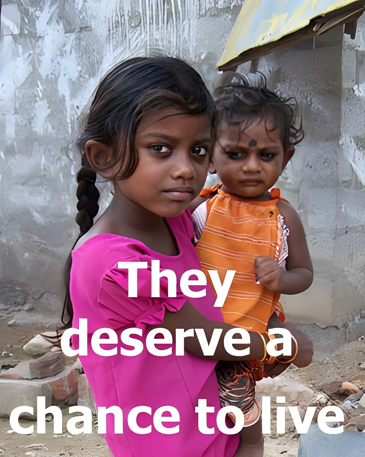 Two young girls looking solemnly at the camera.